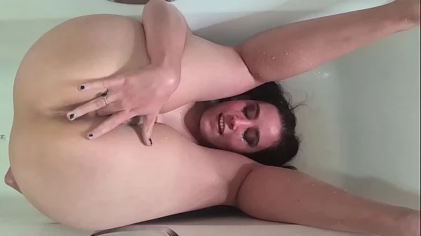 Piss whore pissing over her face in the bathtub